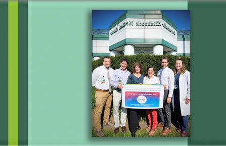 Neurology staff pose with an award certificate outside DHMC.